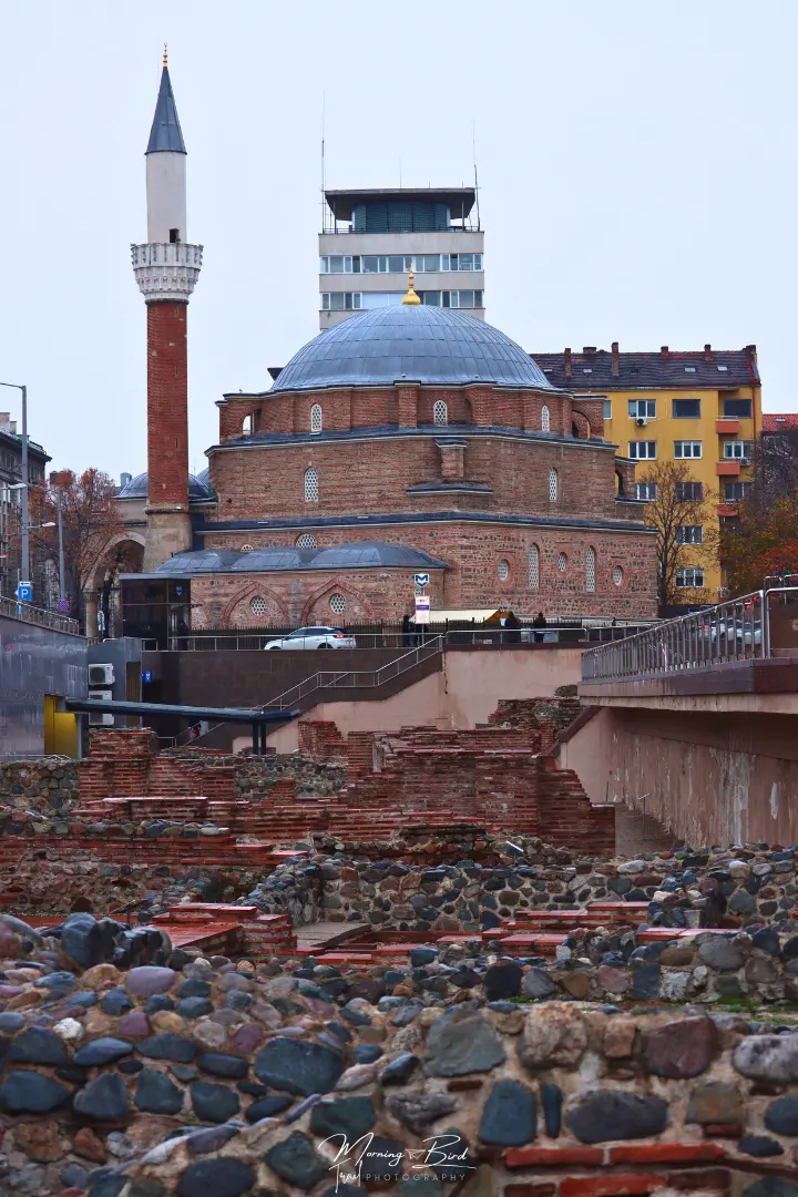 Roman ruins in Sofia city centre with the Sofia mosque (Banya Bashi) in the background.