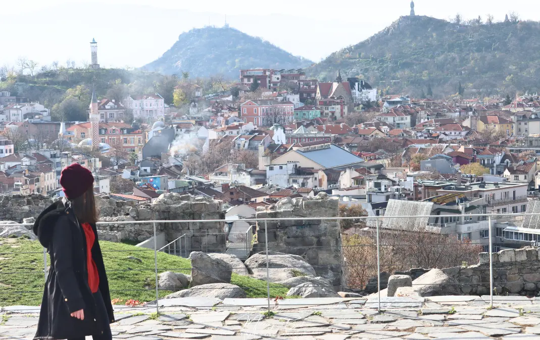 woman looking at the landscape of Plovdiv city centre in Bulgaria with some mountains at the back. - Nebet Tepe Viewpoint 