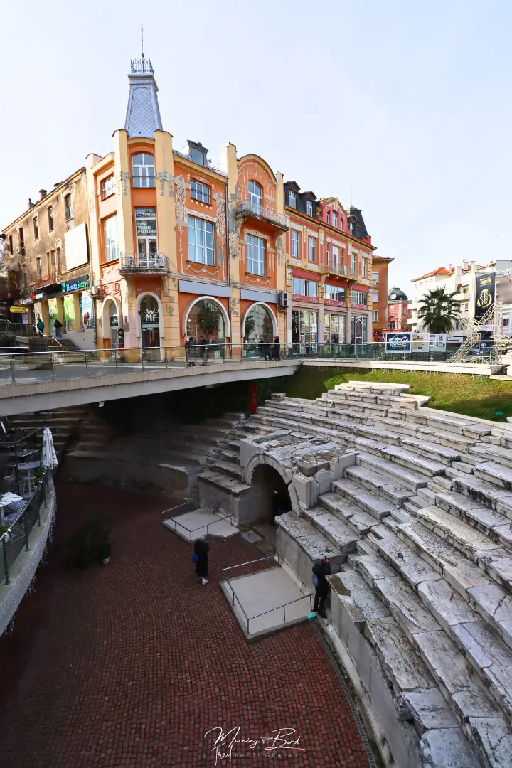 Plovdiv Roman Stadium with an orange and yellow house in the city center