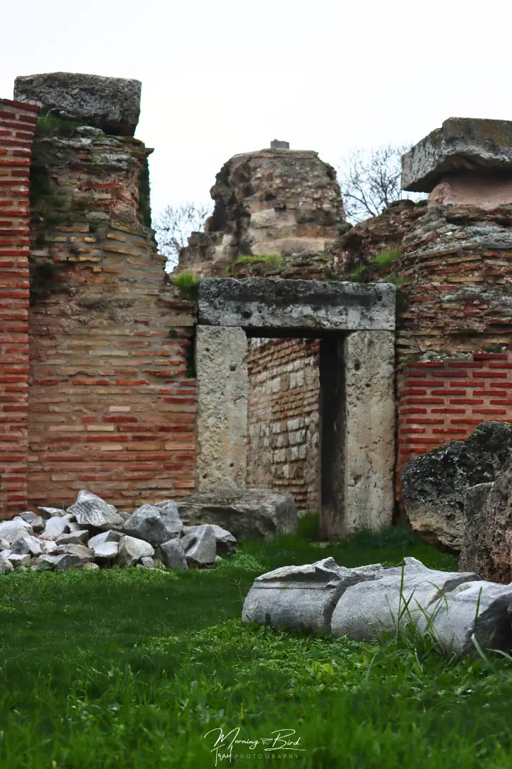 Roman Thermae of Odessos ruins of the thermal baths with very green grass contrasting the orange and white rocks