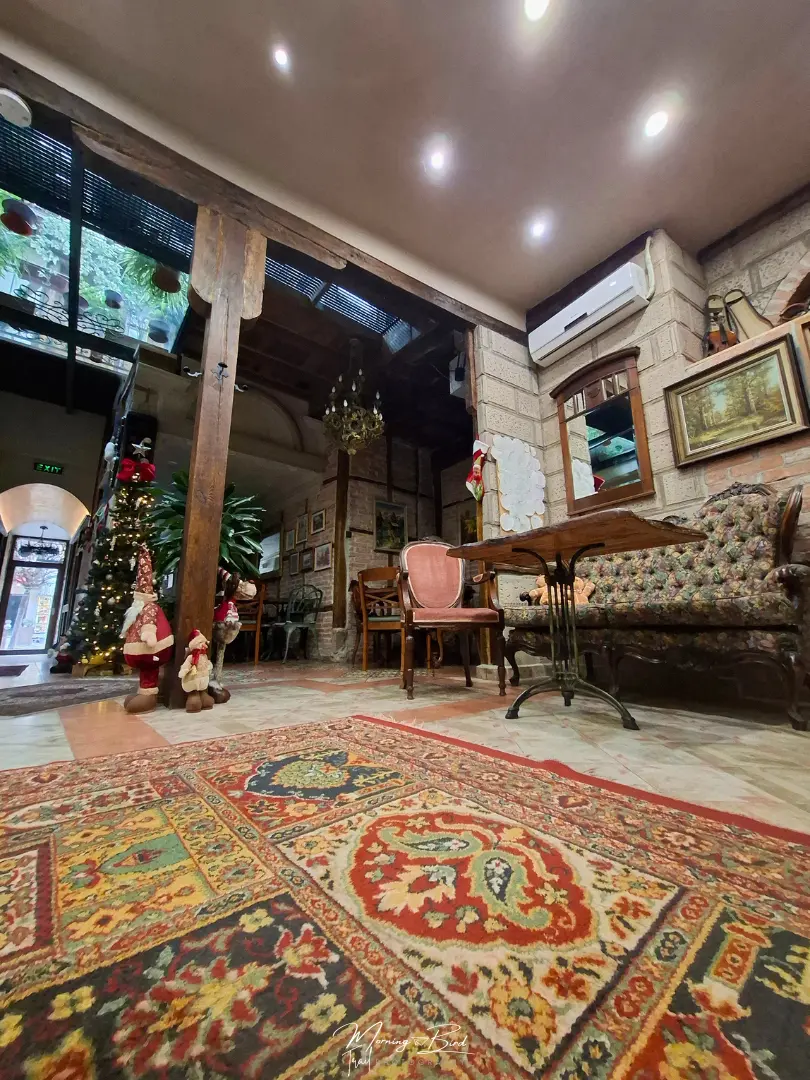 Interior of the Guest house Diabora-Veliko Tarnovo with a beautiful red carpet, christmas decorations and a vintage sofa