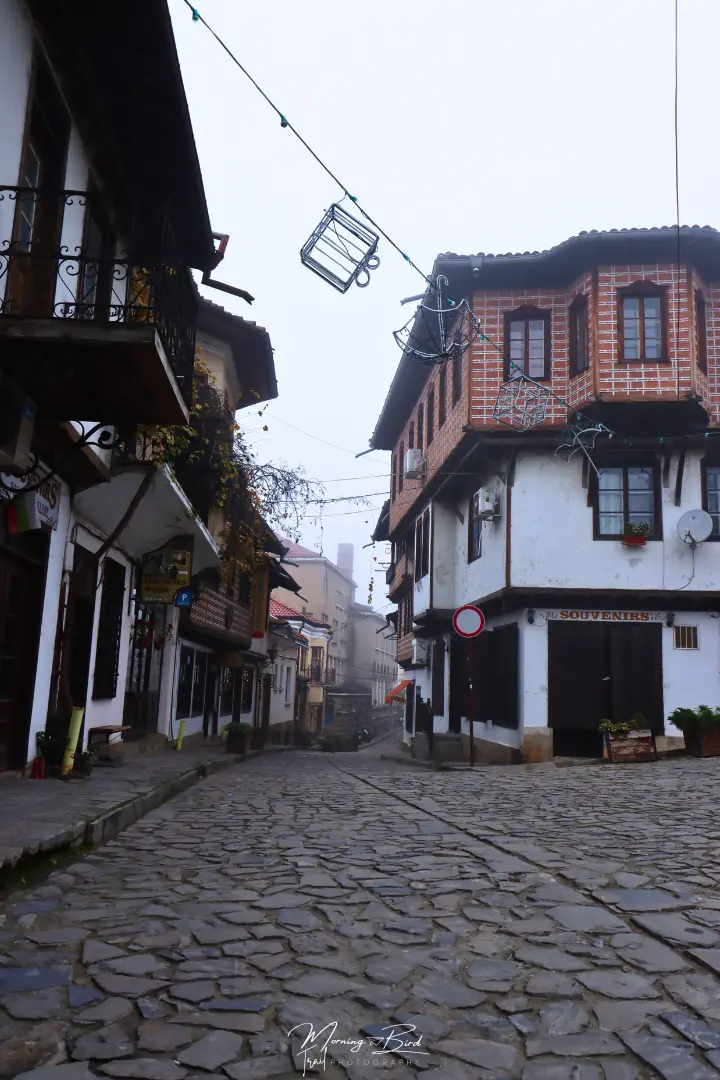 Cobblestone streets with traditional bulgarian houses in Veliko Tarnovo, Bulgaria, decorated with christmas lights