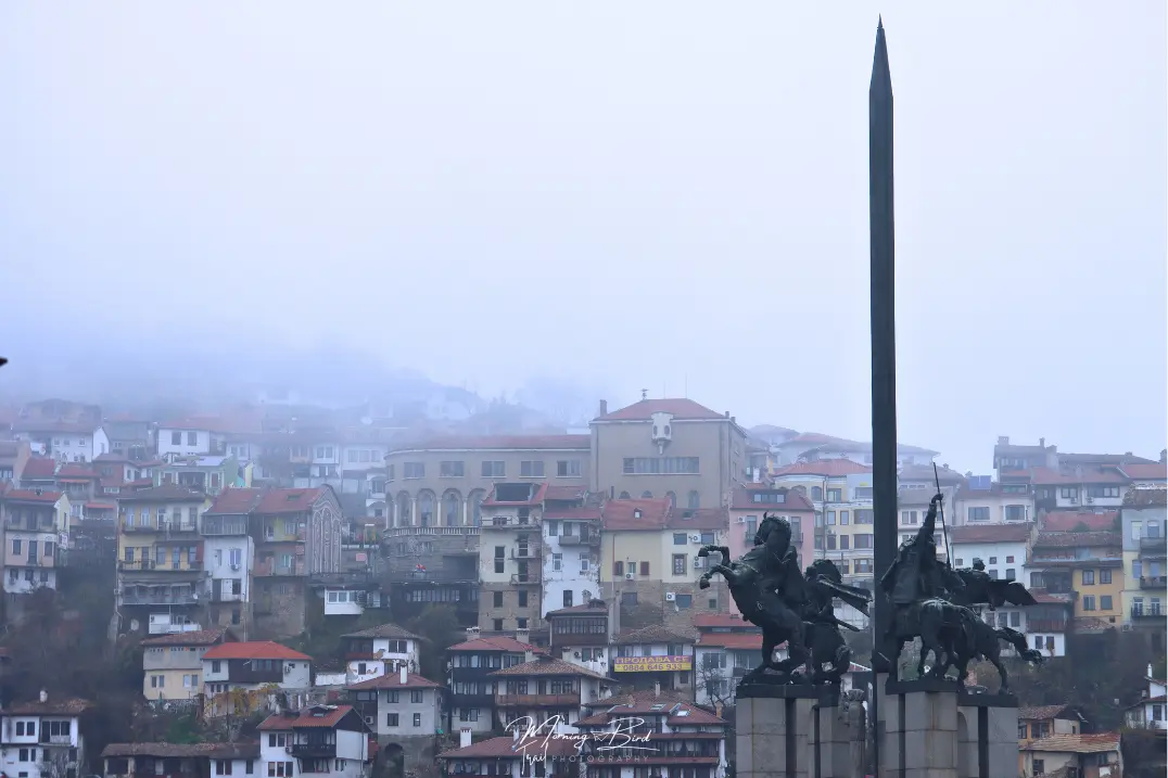 view of Veliko Tarnovo from Asen's Monument. Houses of Veliko Tarnovo half hidden in the fog over the hill